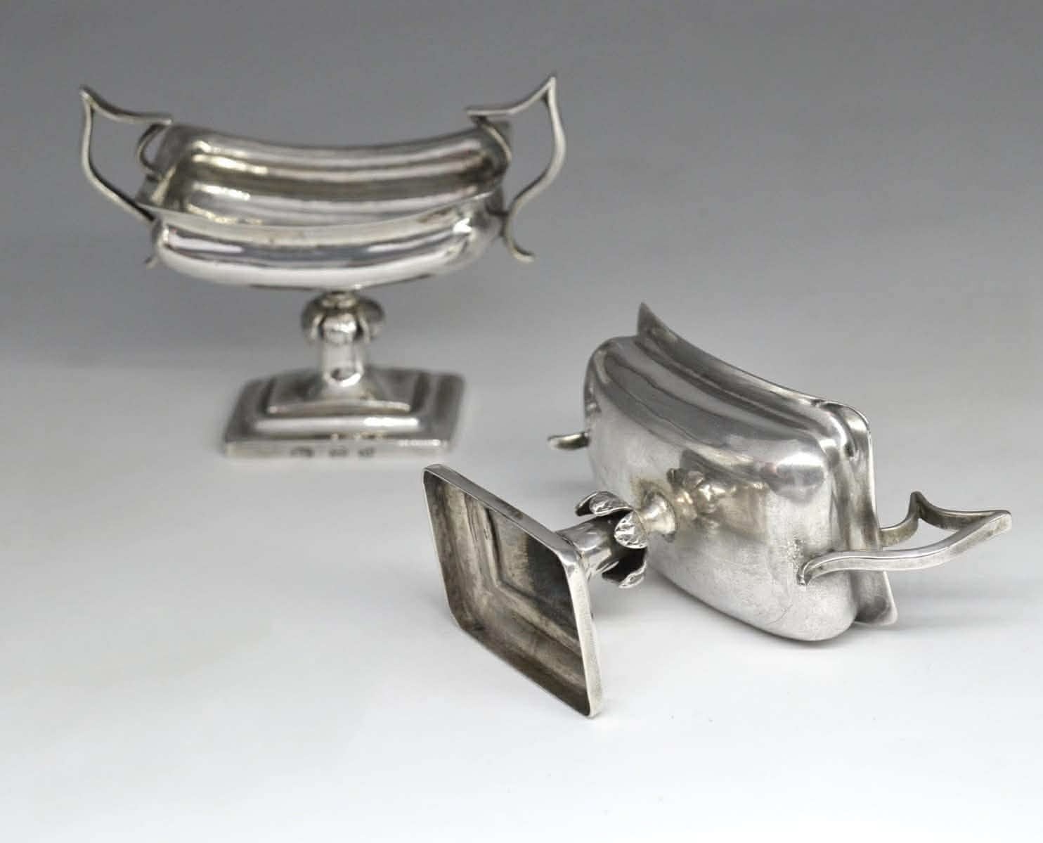A pair of silver salt shakers 4