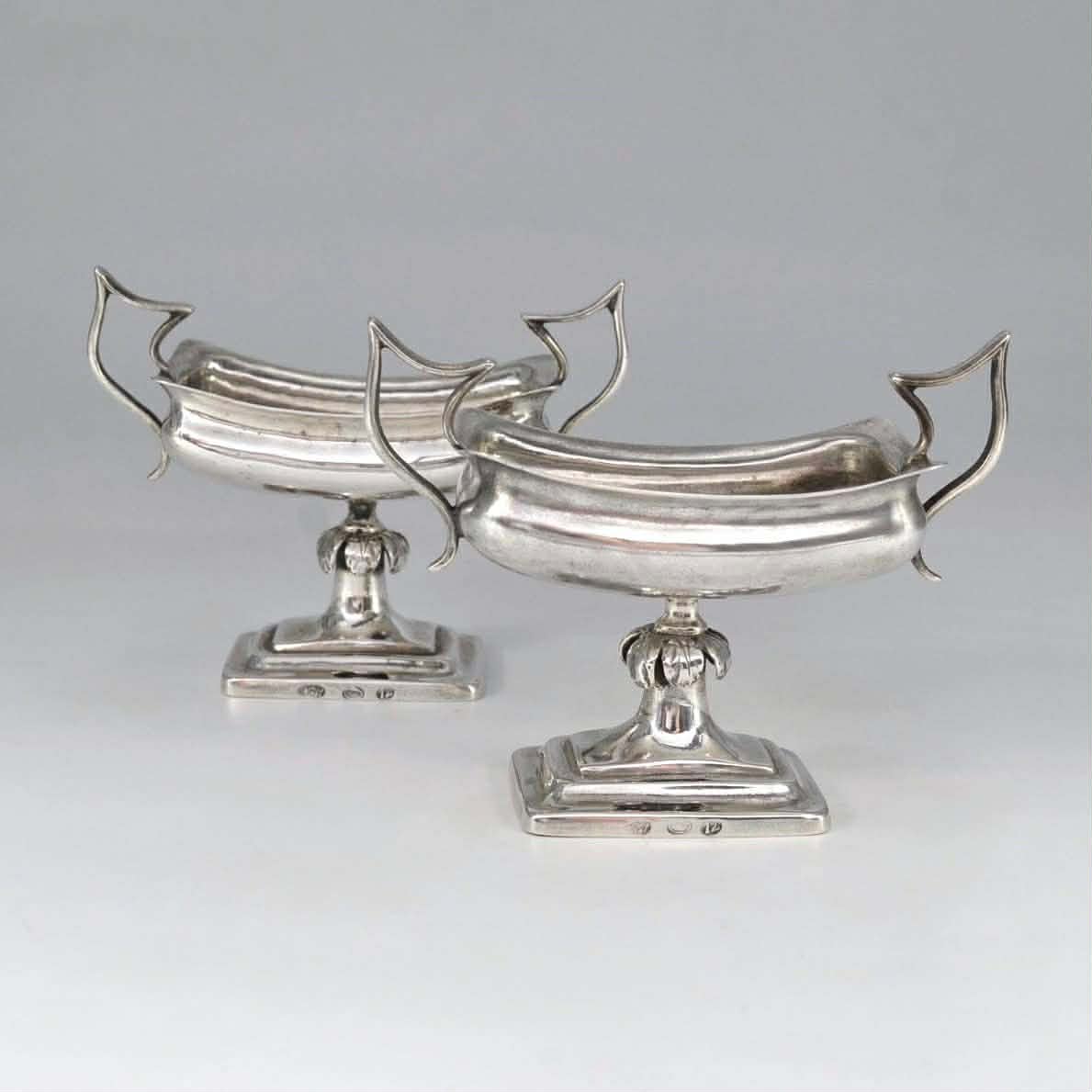 A pair of silver salt shakers 0