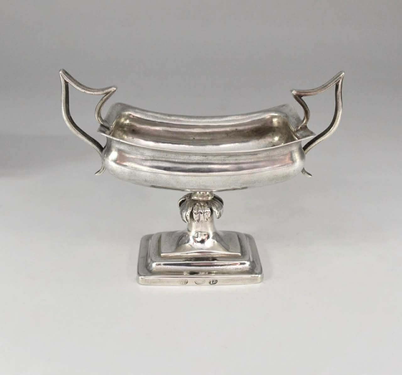 A pair of silver salt shakers 2