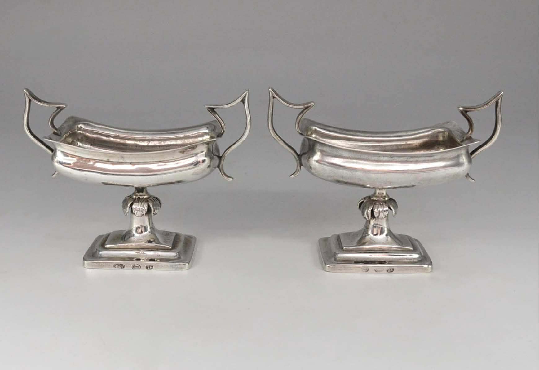A pair of silver salt shakers 1