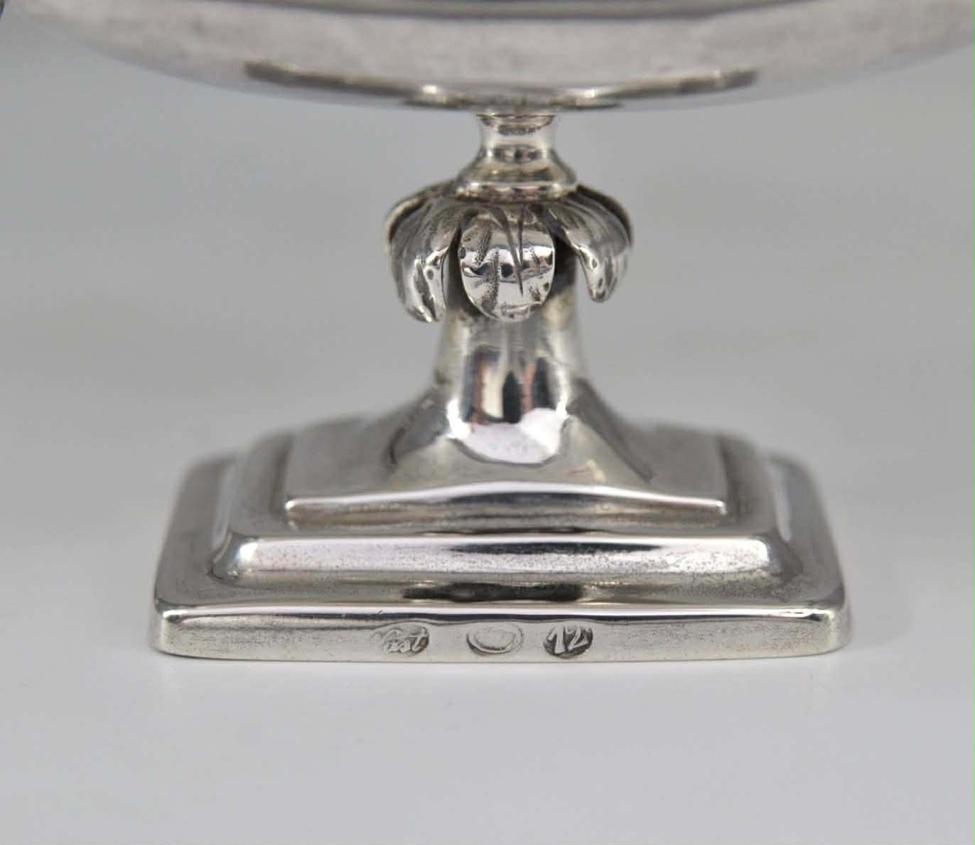A pair of silver salt shakers 3