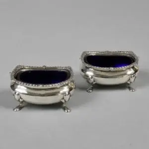 A pair of silver salt shakers