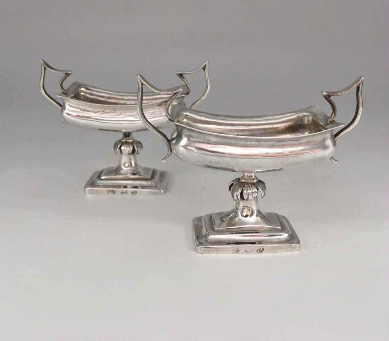 A pair of silver salt shakers