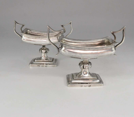 A pair of silver salt shakers